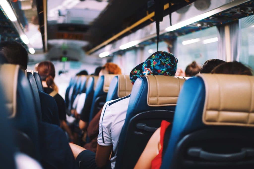 Guests seated aboard an Ambassador Buses coach for event transportation