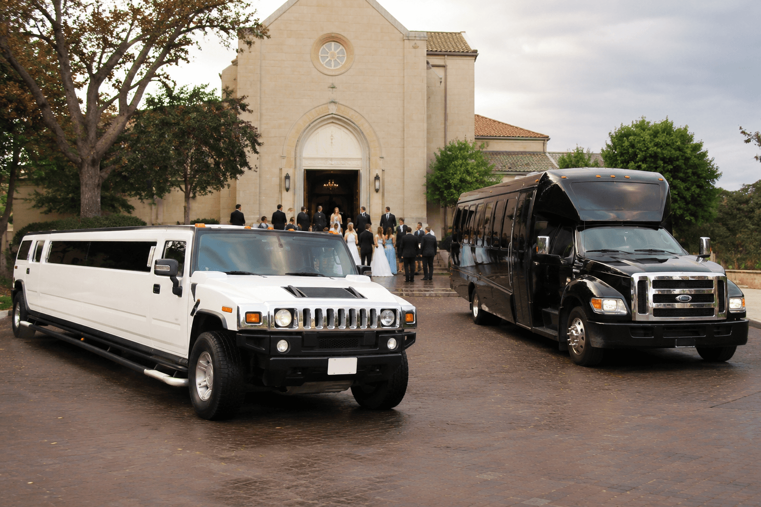 Ambassador Buses Hummer limousine and party bus outside a wedding venue