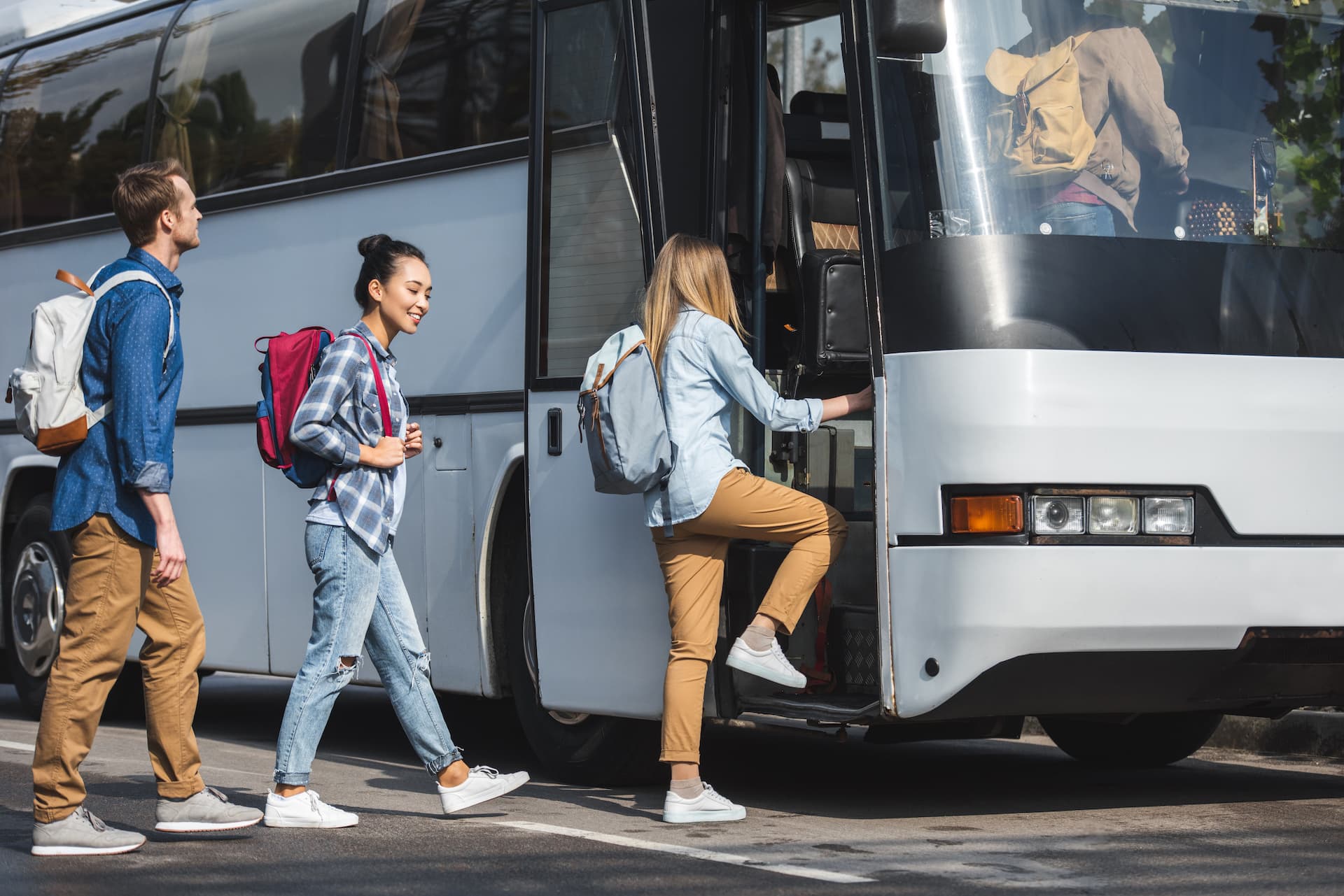 Students boarding an Ambassador Buses coach for a school field trip